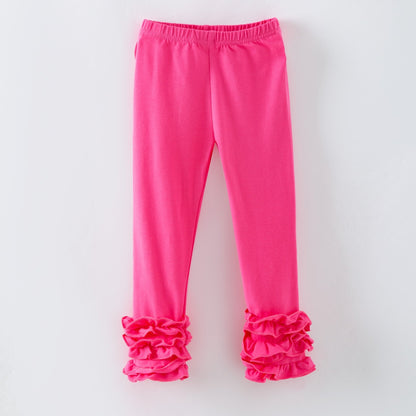 Bright pink leggings with ruffled cuffs on a light gray background