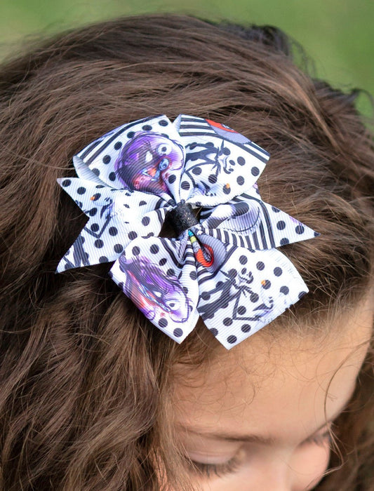 Girl wearing a spooky skeleton stripe hair bow