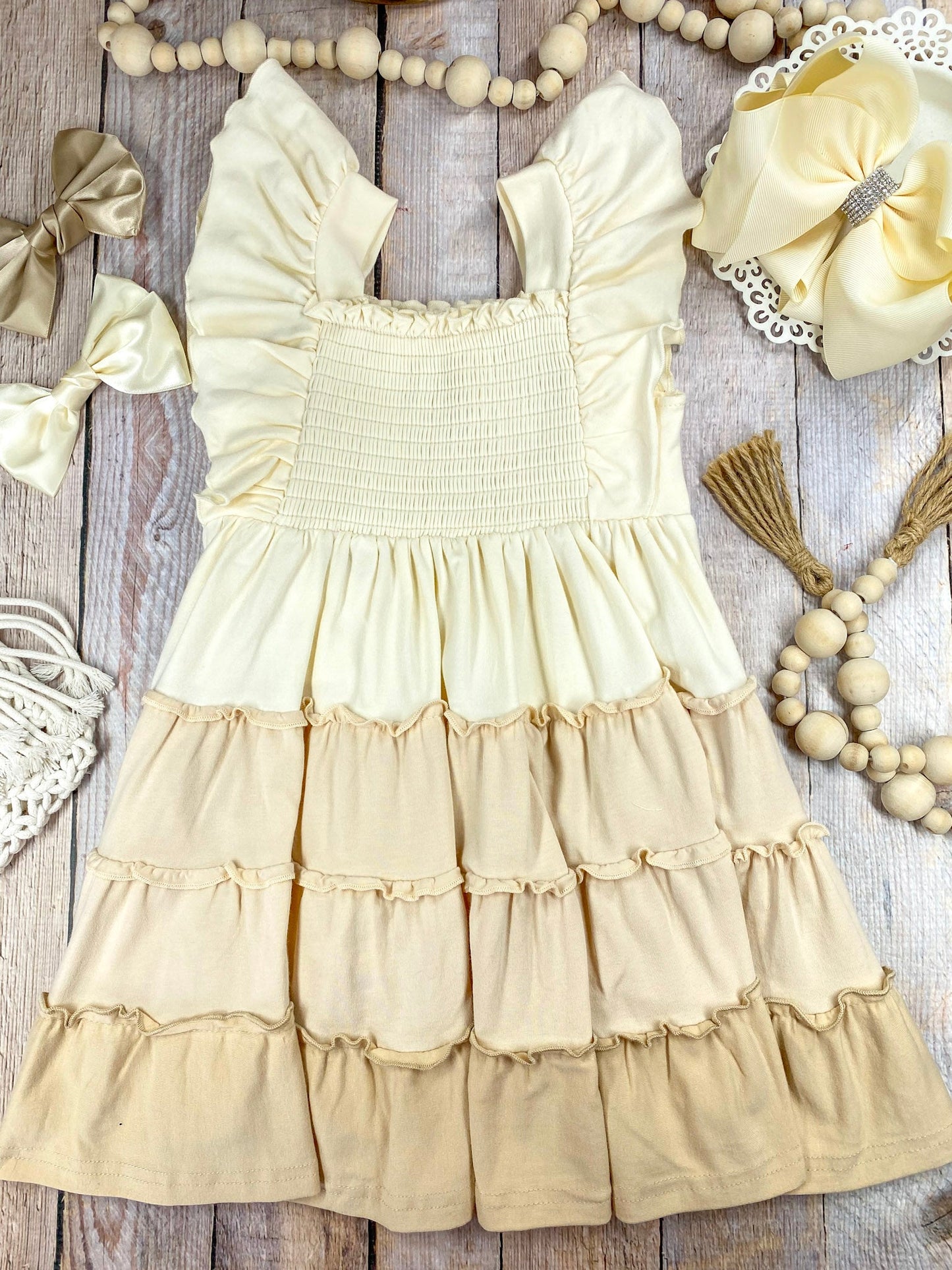 neutral tiered dress on a wooden background