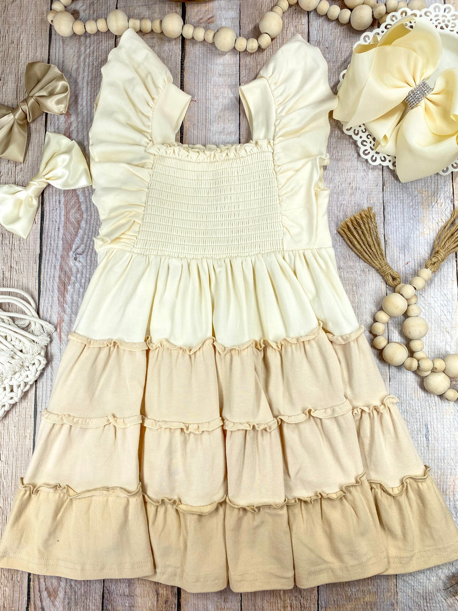 neutral tiered dress on a wooden background