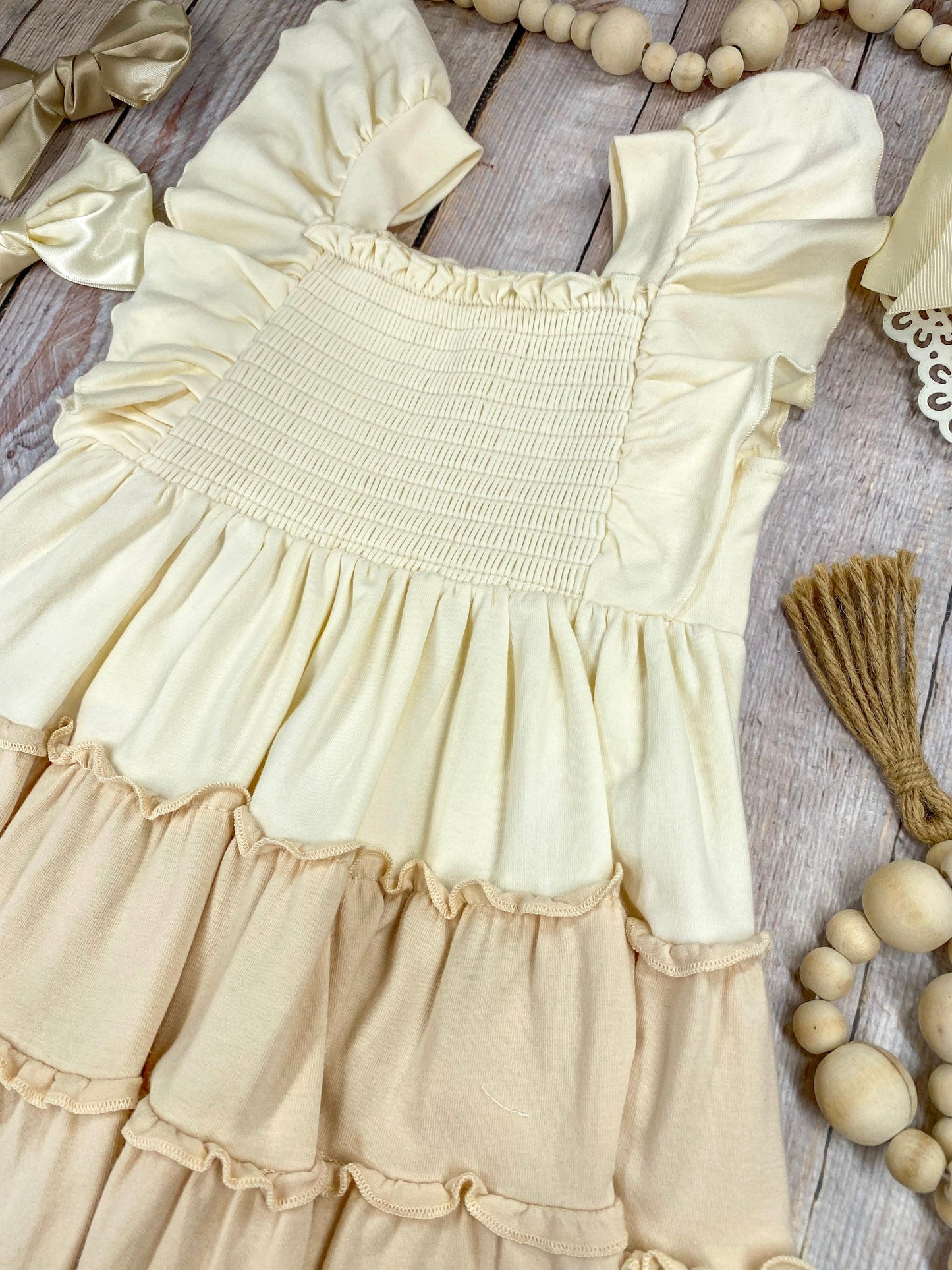 neutral tiered dress on a wooden background