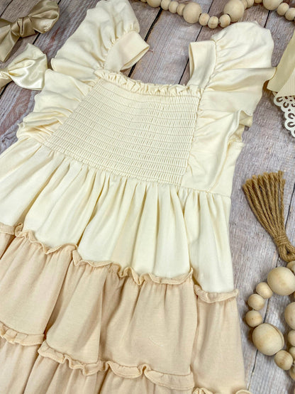 neutral tiered dress on a wooden background