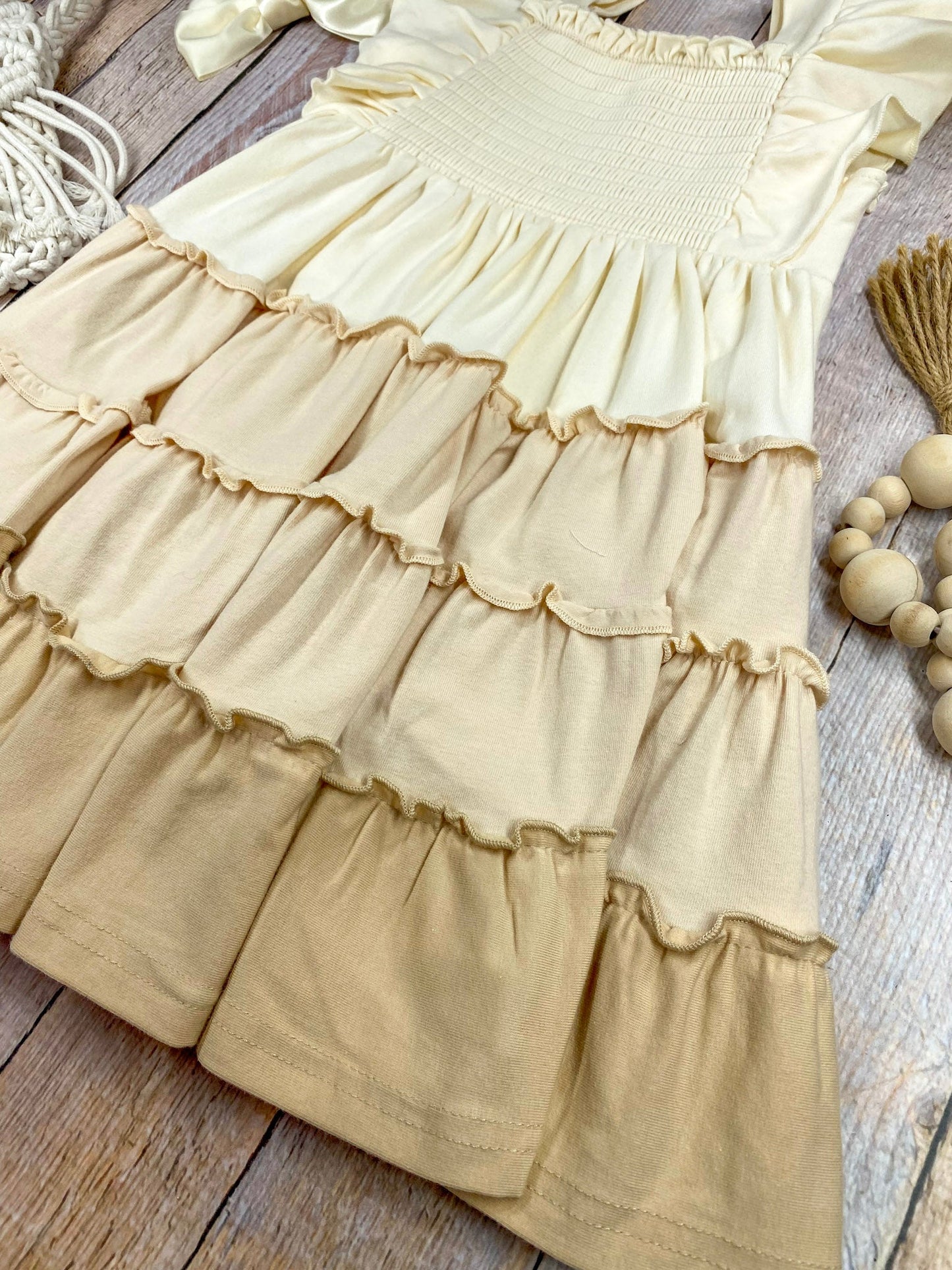 neutral tiered dress on a wooden background