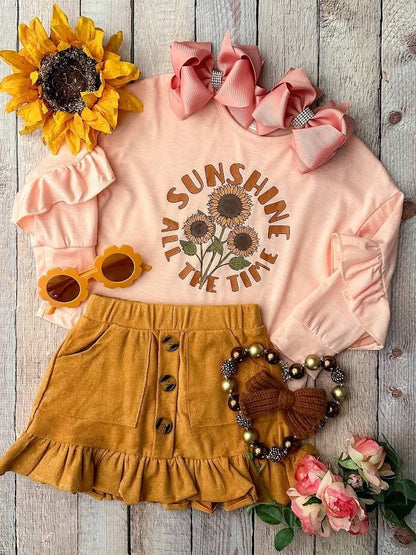 Peach Long Sleeve Top With Sunflowers, & Mustard Button Skirt.