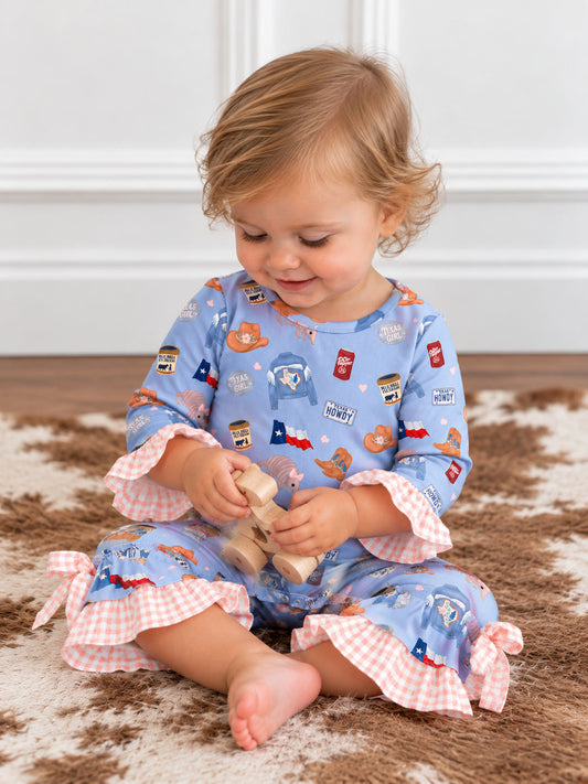 model wearing a Blue Texas print baby romper with pink gingham ruffles and bows at the ankles
