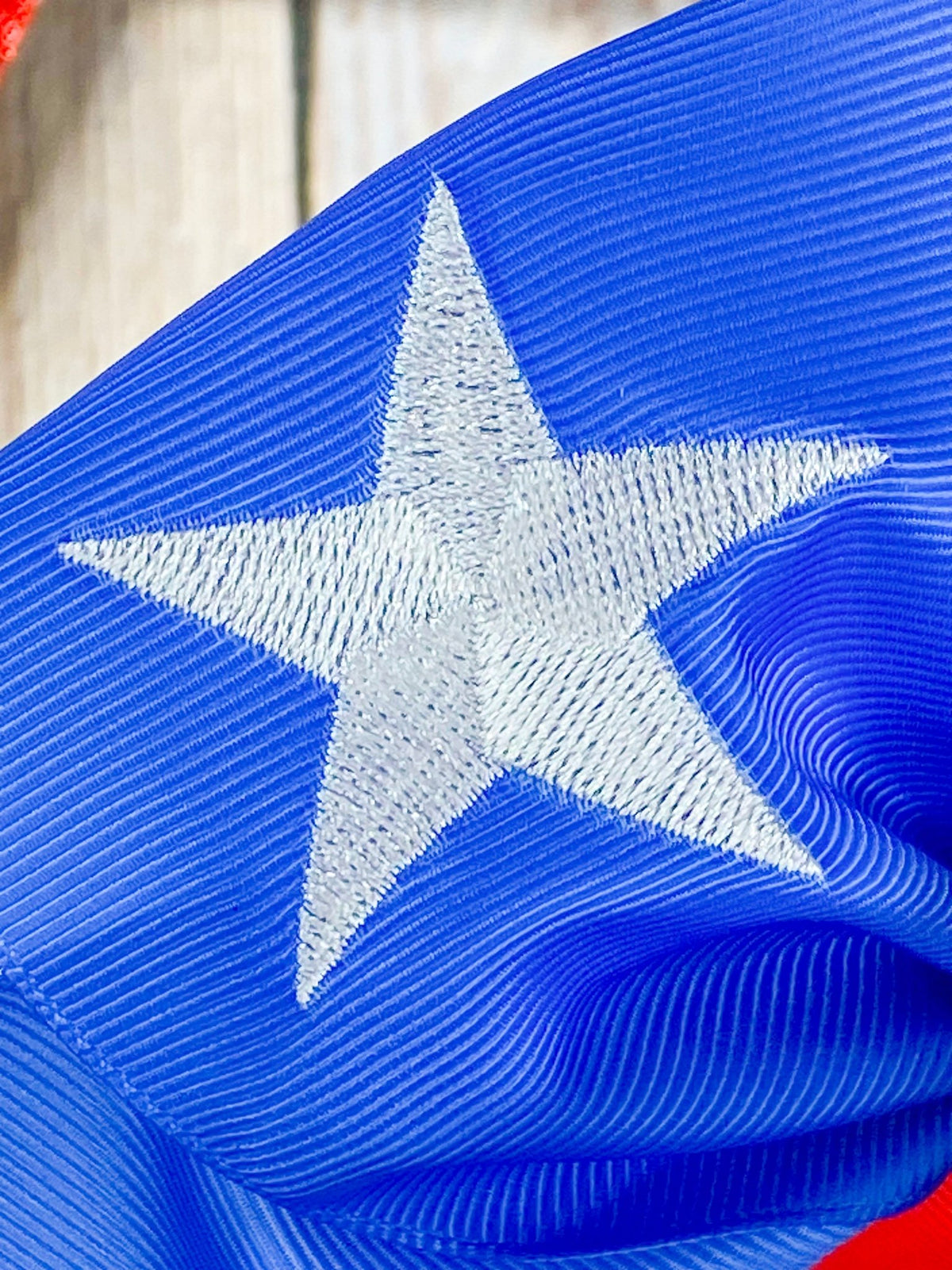 Close-up of embroidered Texas star on cheer bow