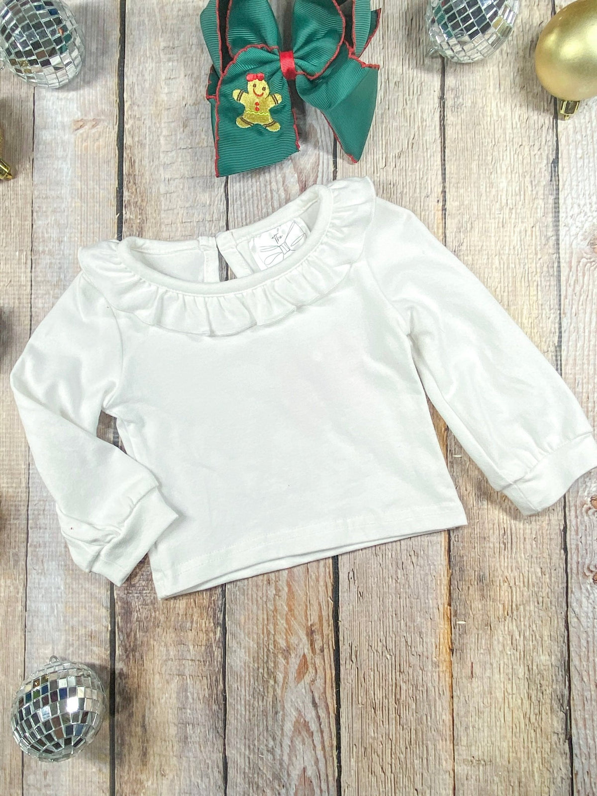 White ruffle collar long sleeve top worn under the gingerbread romper
