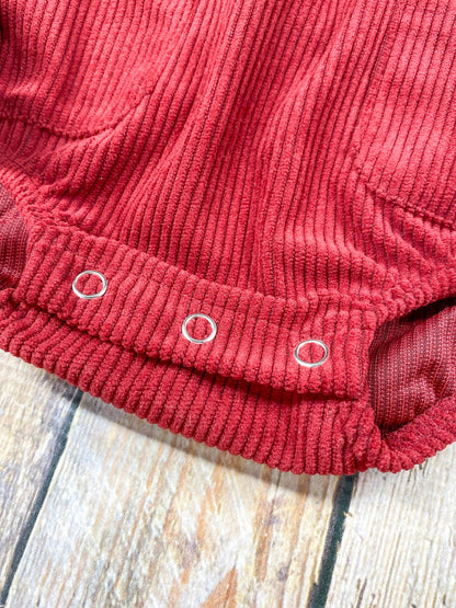 Close-up of the snaps at the bottom of the corduroy romper