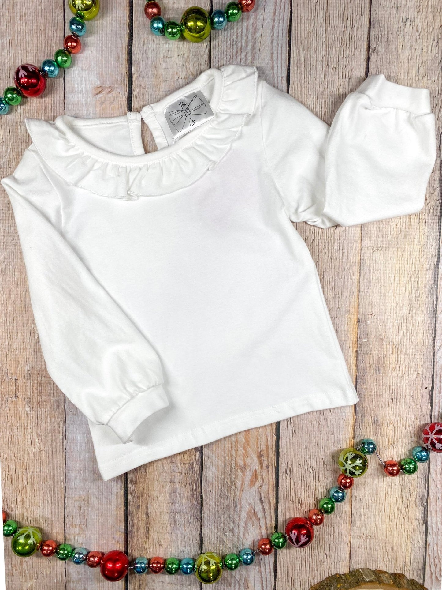 the white long sleeve with ruffle collar by itself