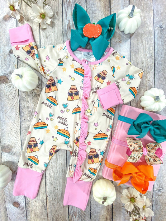 Cream baby romper with turkeys in sunglasses and pie slices