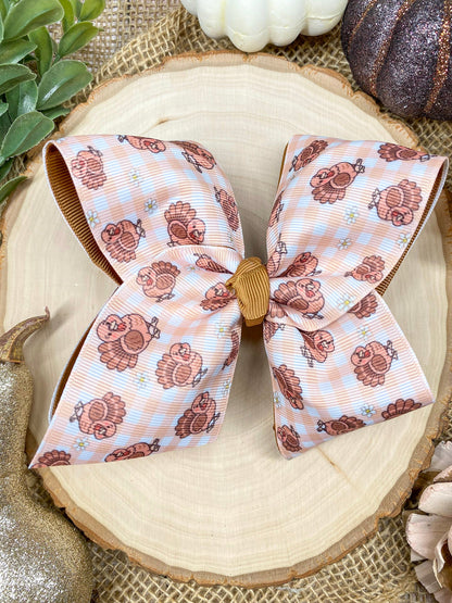 Turkey Print Hair Bow on a wooden background