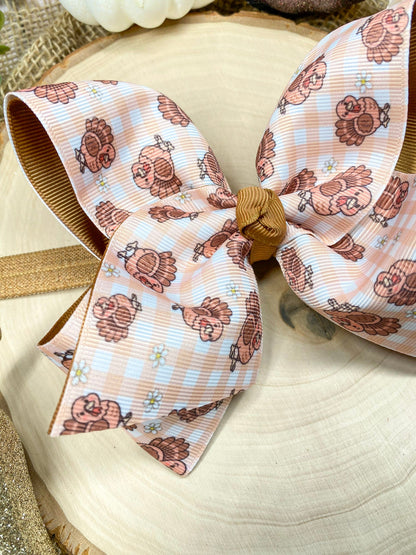 Turkey Print Hair Bow on a wooden background