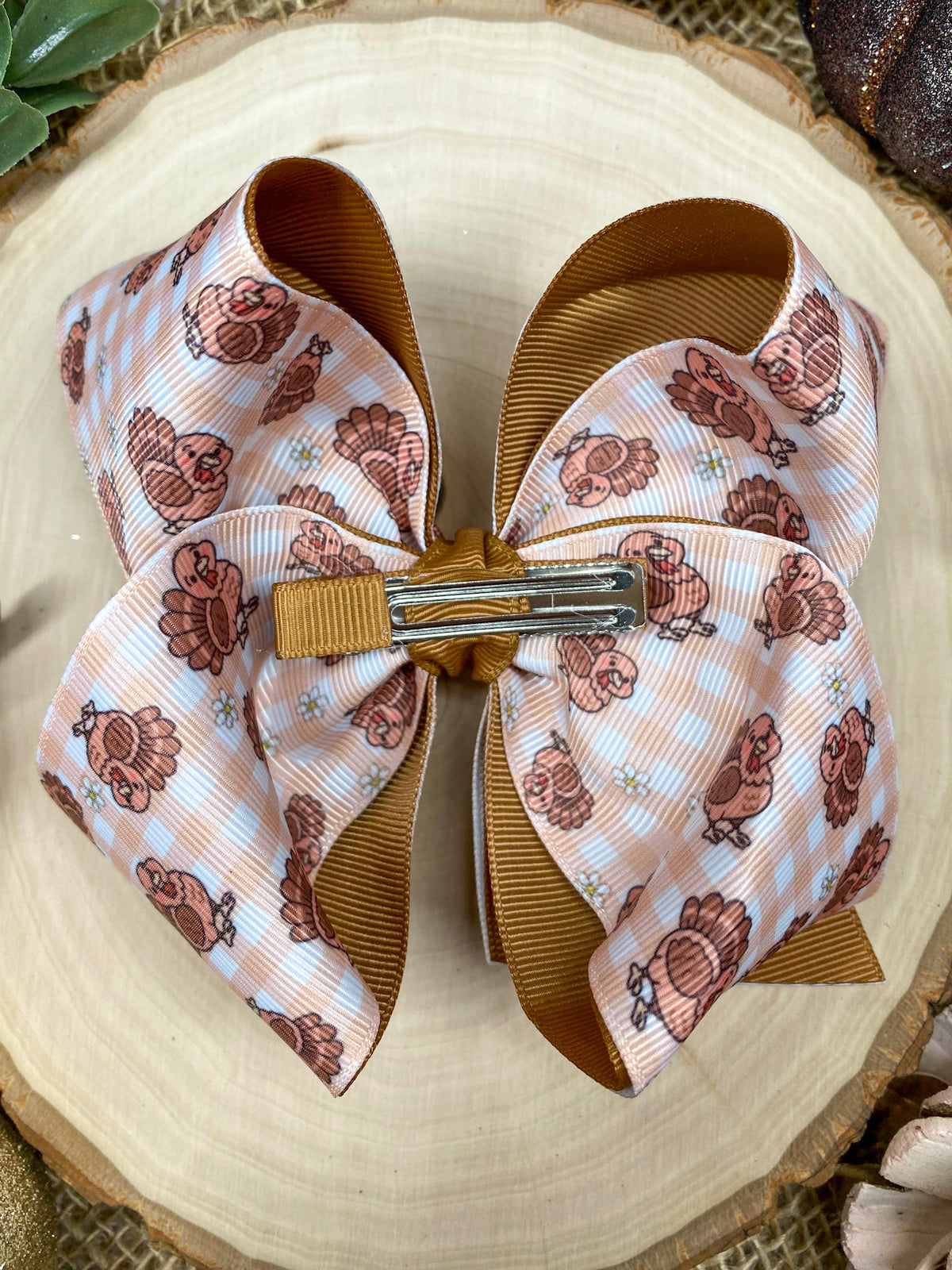 Turkey Print Hair Bow on a wooden background