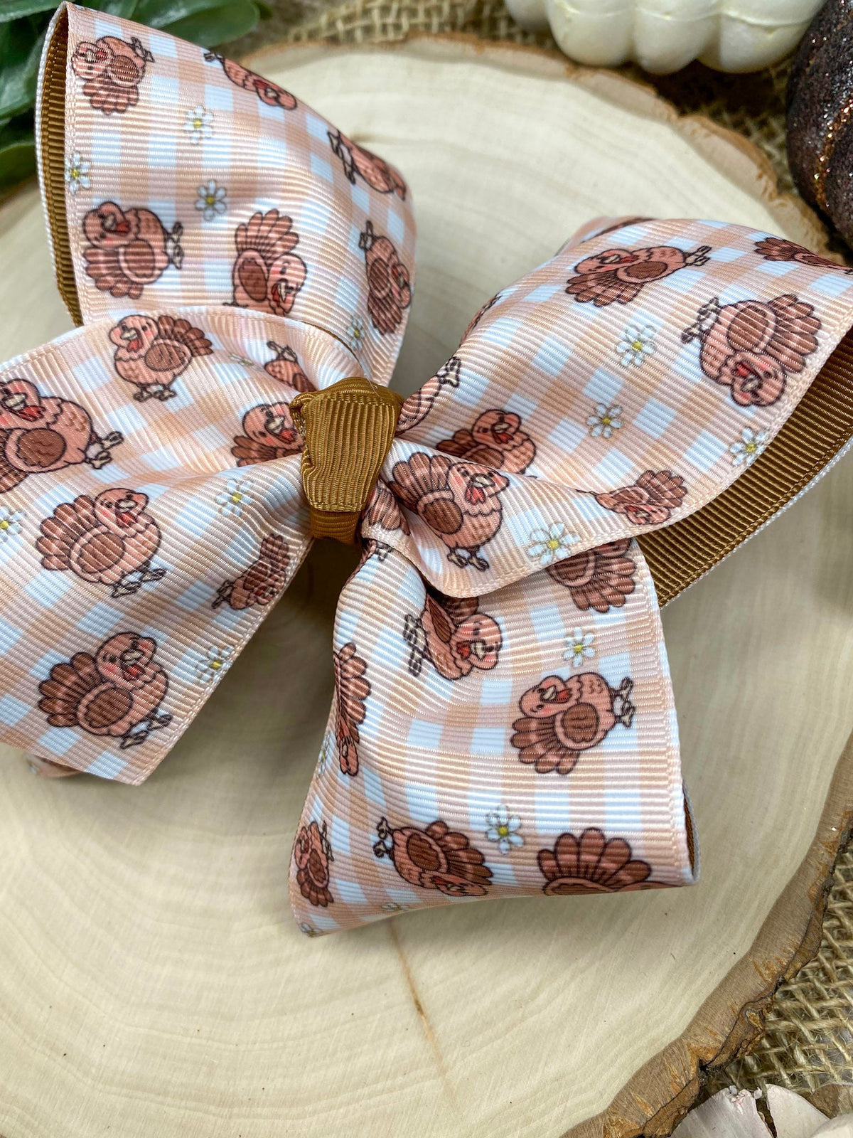 Turkey Print Hair Bow on a wooden background