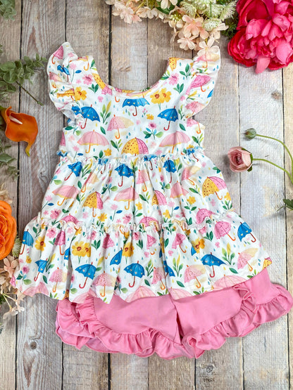 Umbrella print ruffle top and shorts set on decorative wood