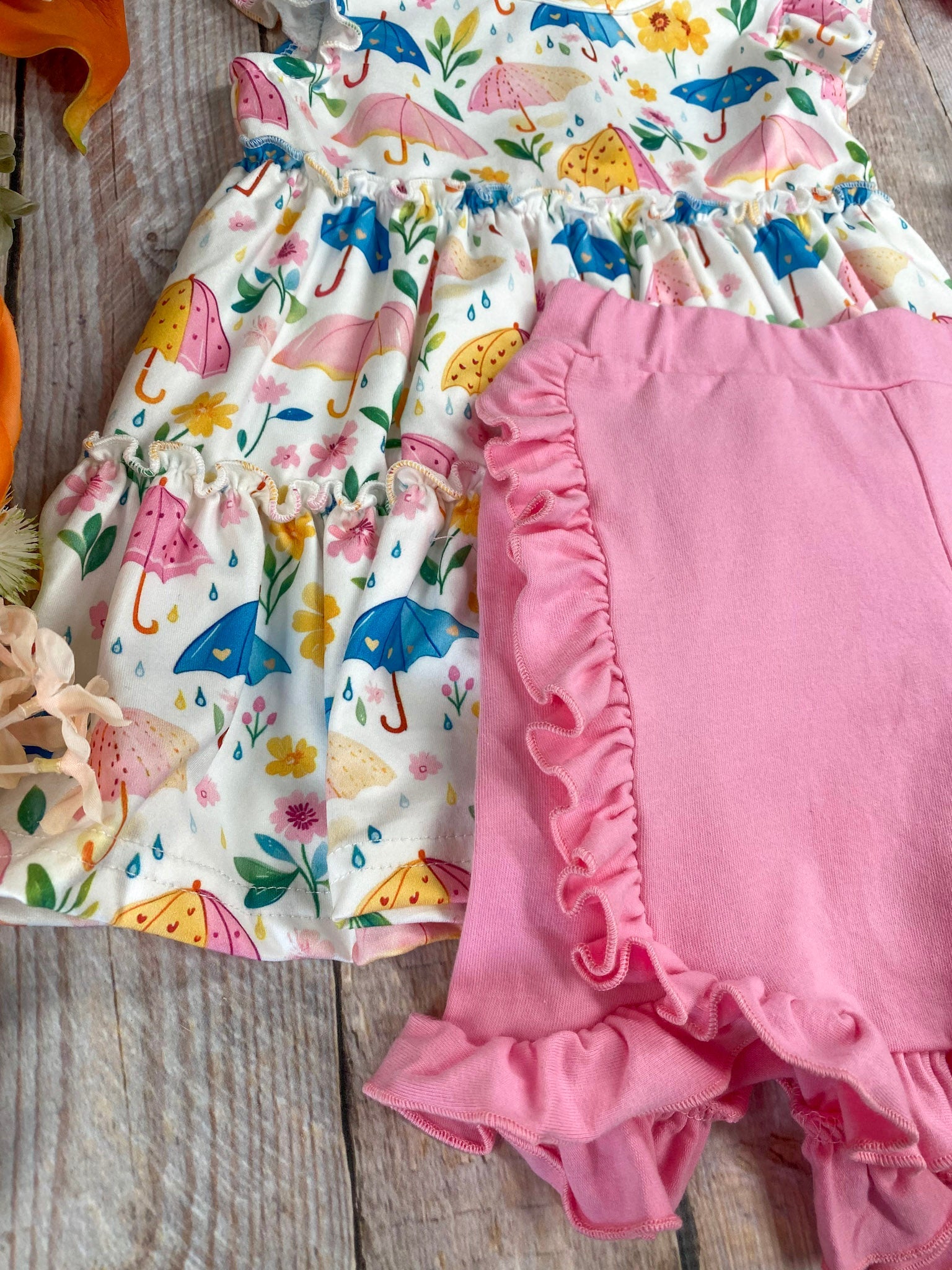 ruffle detail on shorts and umbrella print fabric detail on top