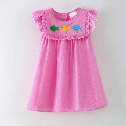 Pink dress with colorful fish appliqués on a white background