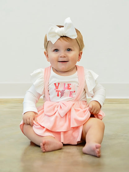 valentine's day baby wearing pink romper from The Hair Bow Company