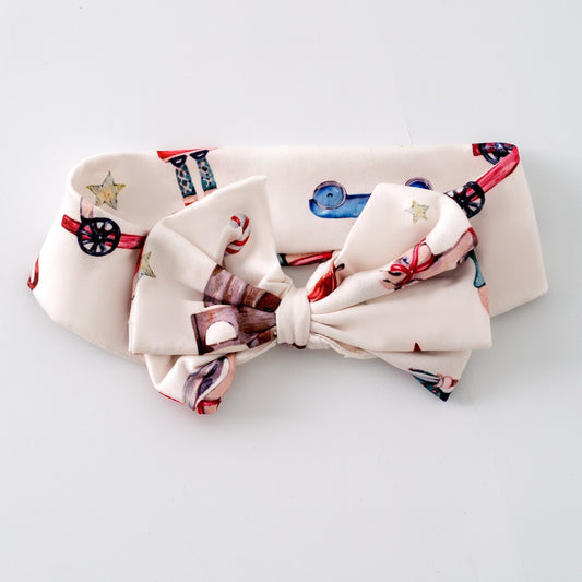 Very Vintage Christmas bow headband with rocking horse and nutcracker print
