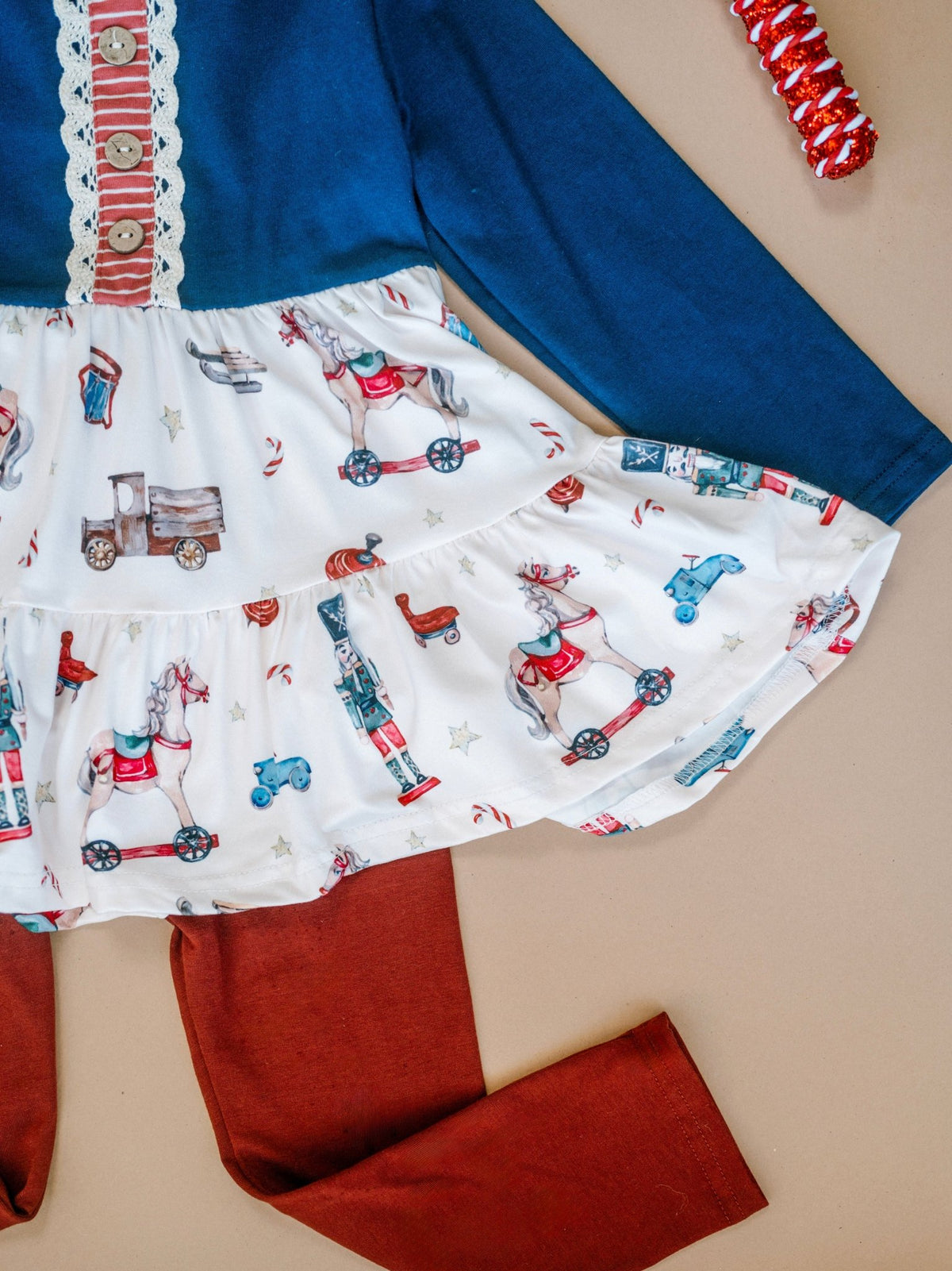 Close-up of the vintage Christmas toys print fabric on the girls leggings set