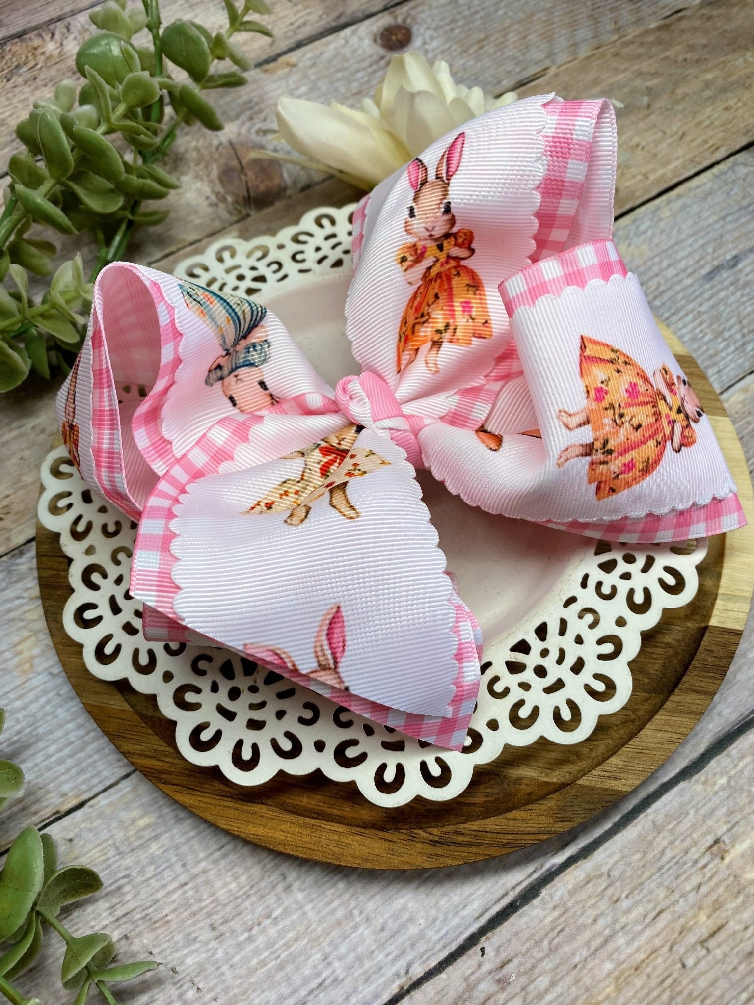 Decorative hair bow with easter bunnies on a wooden surface