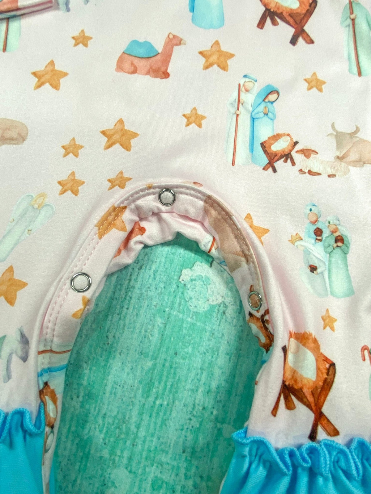 Snap closures along the inseam of the nativity scene baby romper