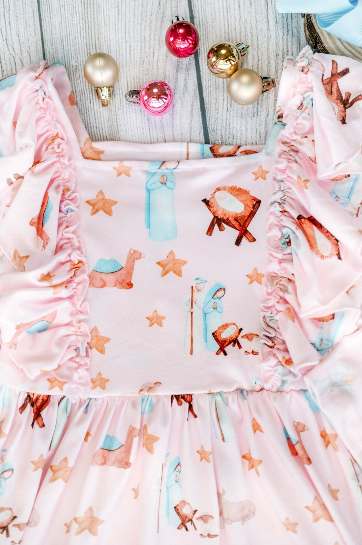 Nativity animal print twirl dress laid flat with Christmas ornaments