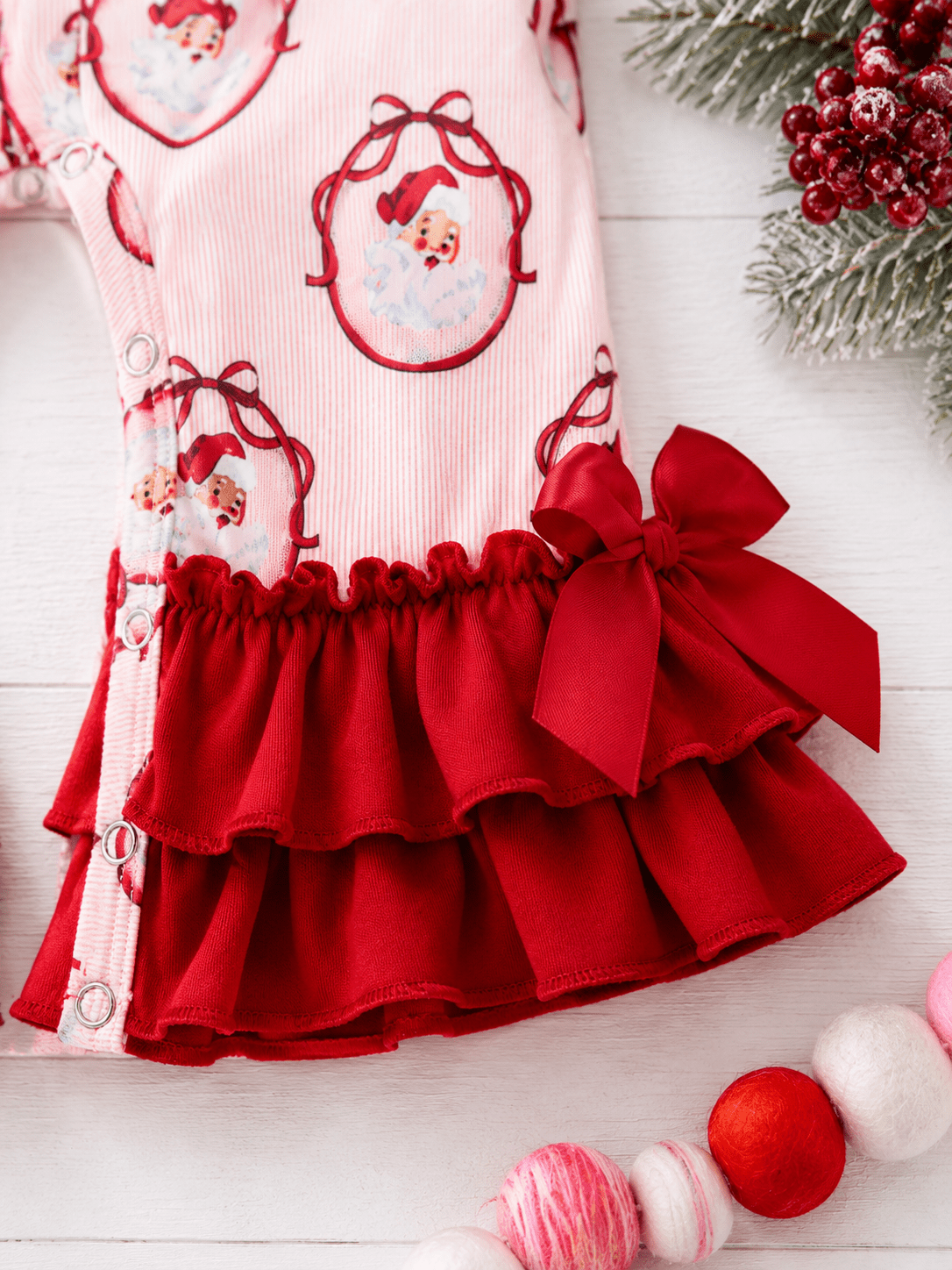 zoomed image of pink santa infant romper fabric
