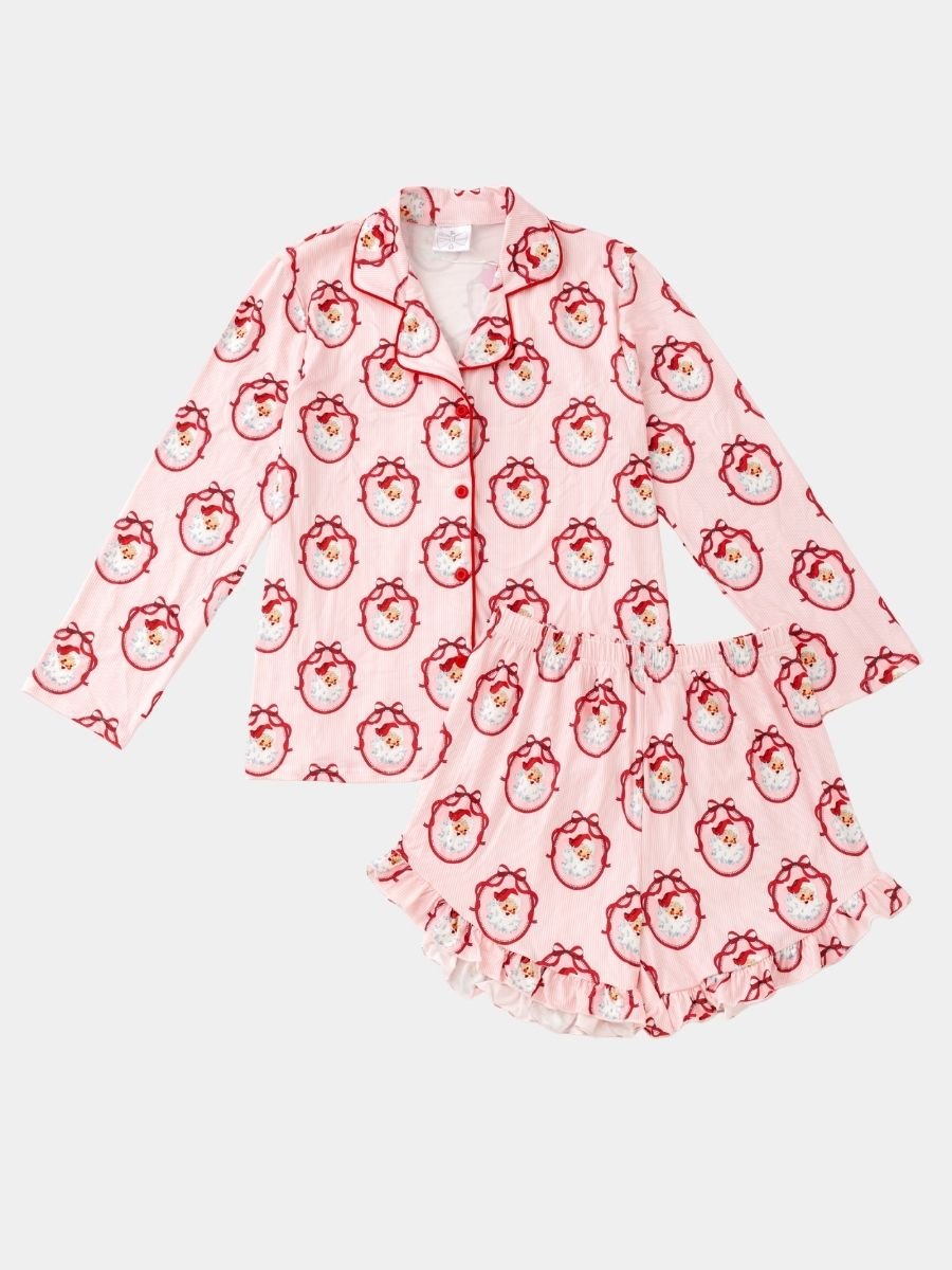 Women's Vintage Santa Christmas pajama set with classic Santa print, button-front top, and ruffle shorts.