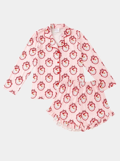 Women's Vintage Santa Christmas pajama set with classic Santa print, button-front top, and ruffle shorts.