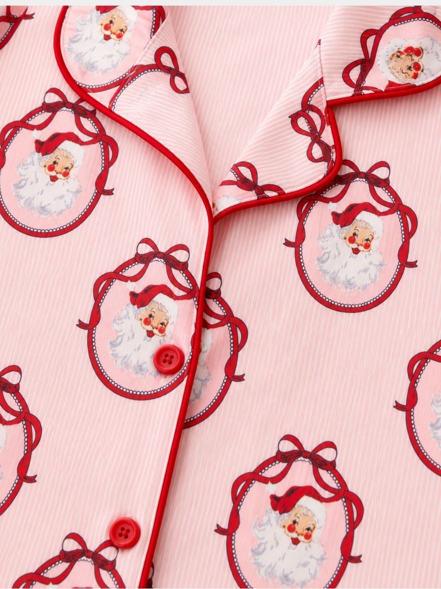 Vintage Santa Mommy & Me Christmas pajama set close-up with classic Santa print, red piping, and button-front top.