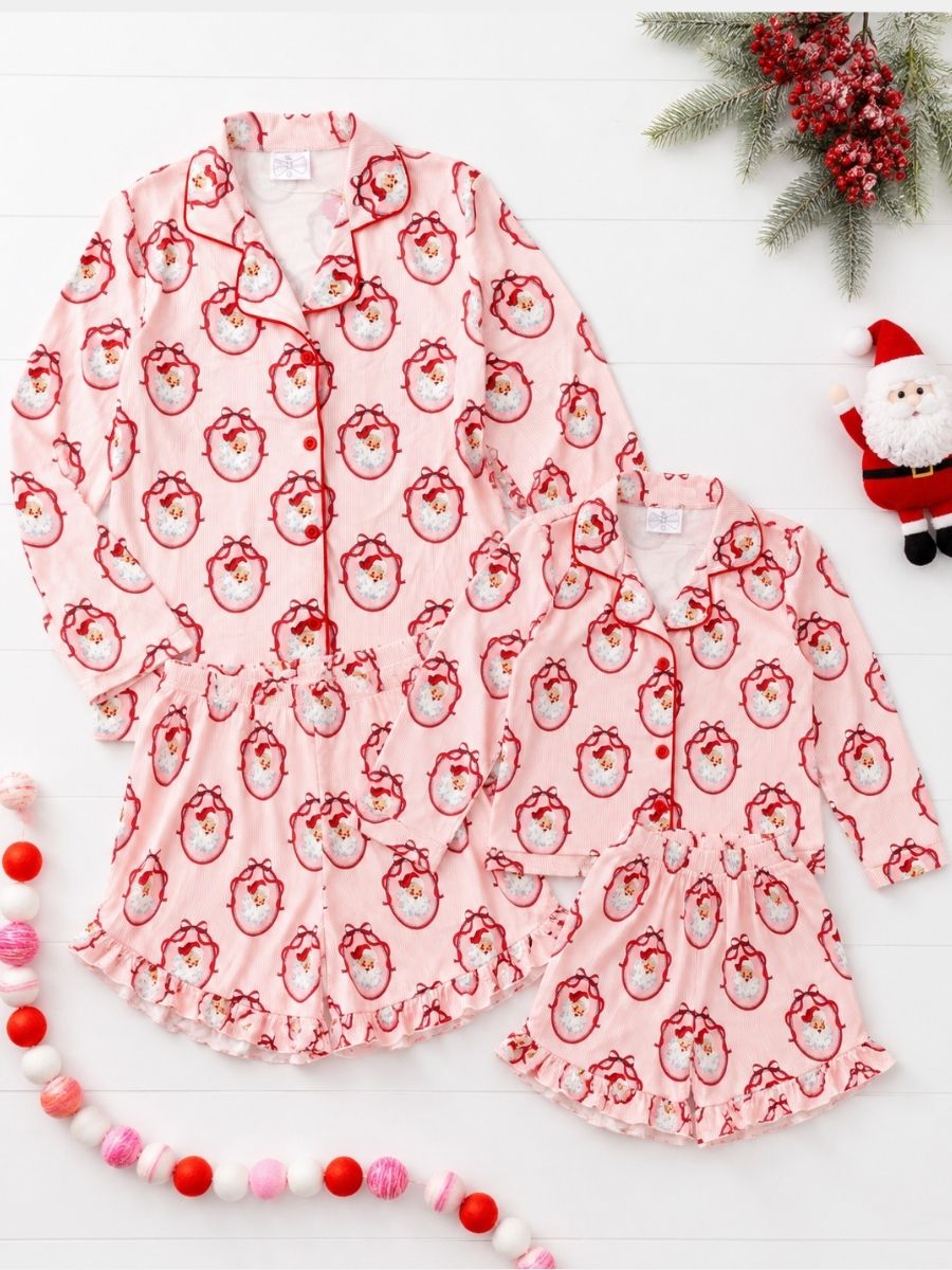 Vintage Santa Mommy & Me matching Christmas pajamas with classic Santa print in a festive holiday flatlay.