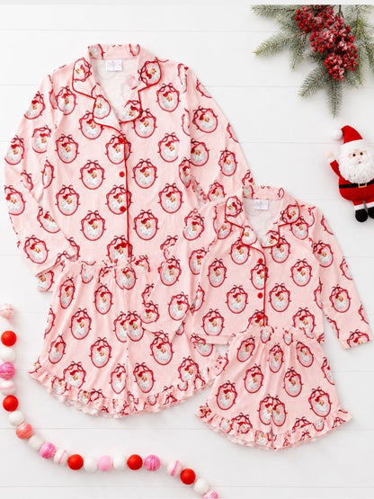 Vintage Santa Mommy & Me matching Christmas pajamas with classic Santa print in a festive holiday flatlay.