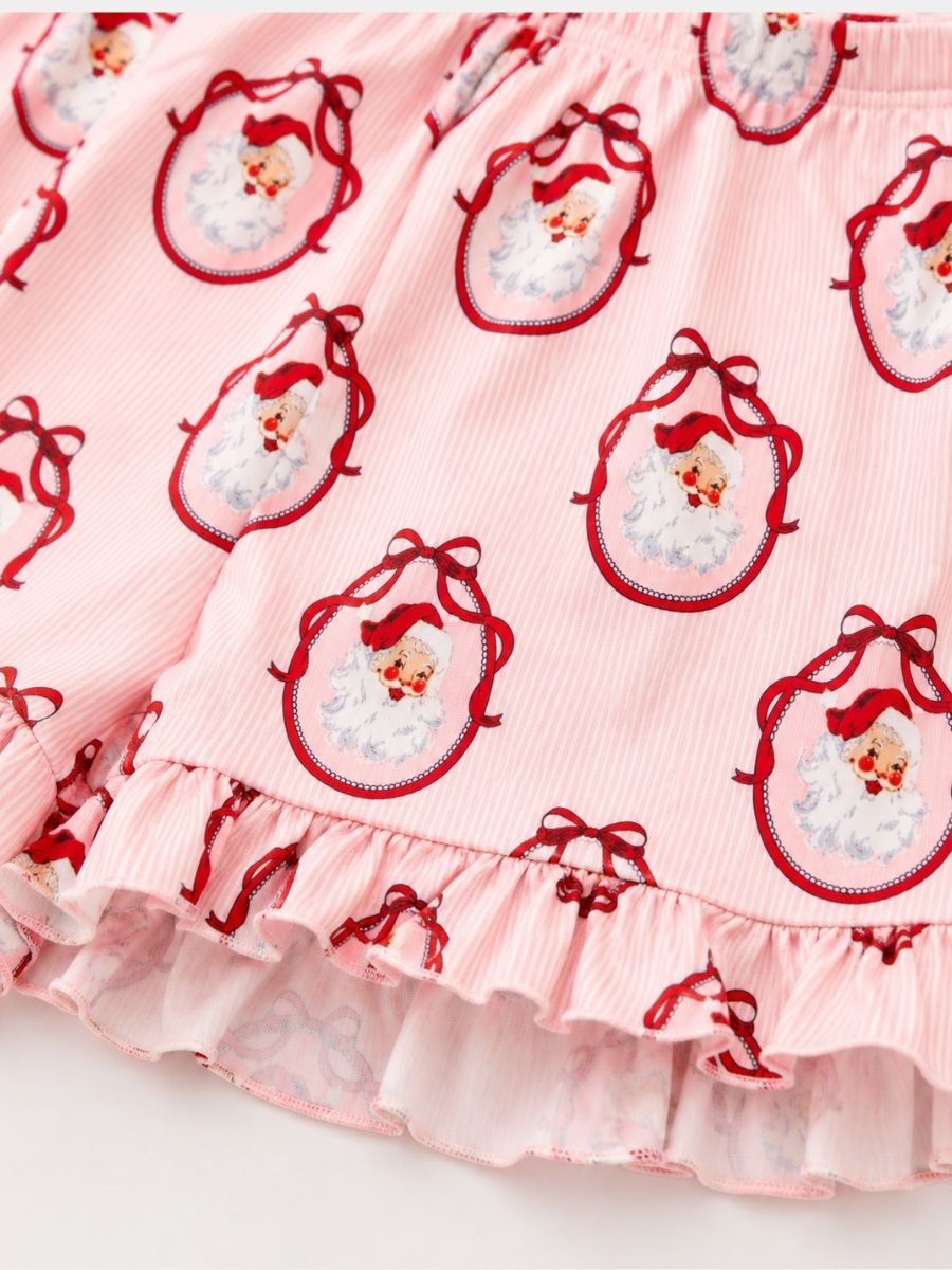 Close-up of Vintage Santa Mommy & Me Christmas pajamas featuring a classic Santa print, soft fabric, and ruffle shorts.