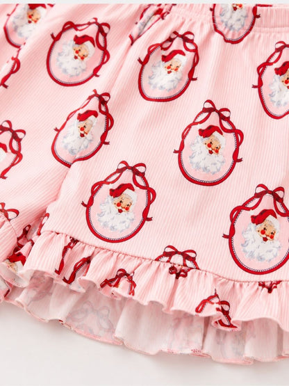 Close-up of Vintage Santa Mommy & Me Christmas pajamas featuring a classic Santa print, soft fabric, and ruffle shorts.