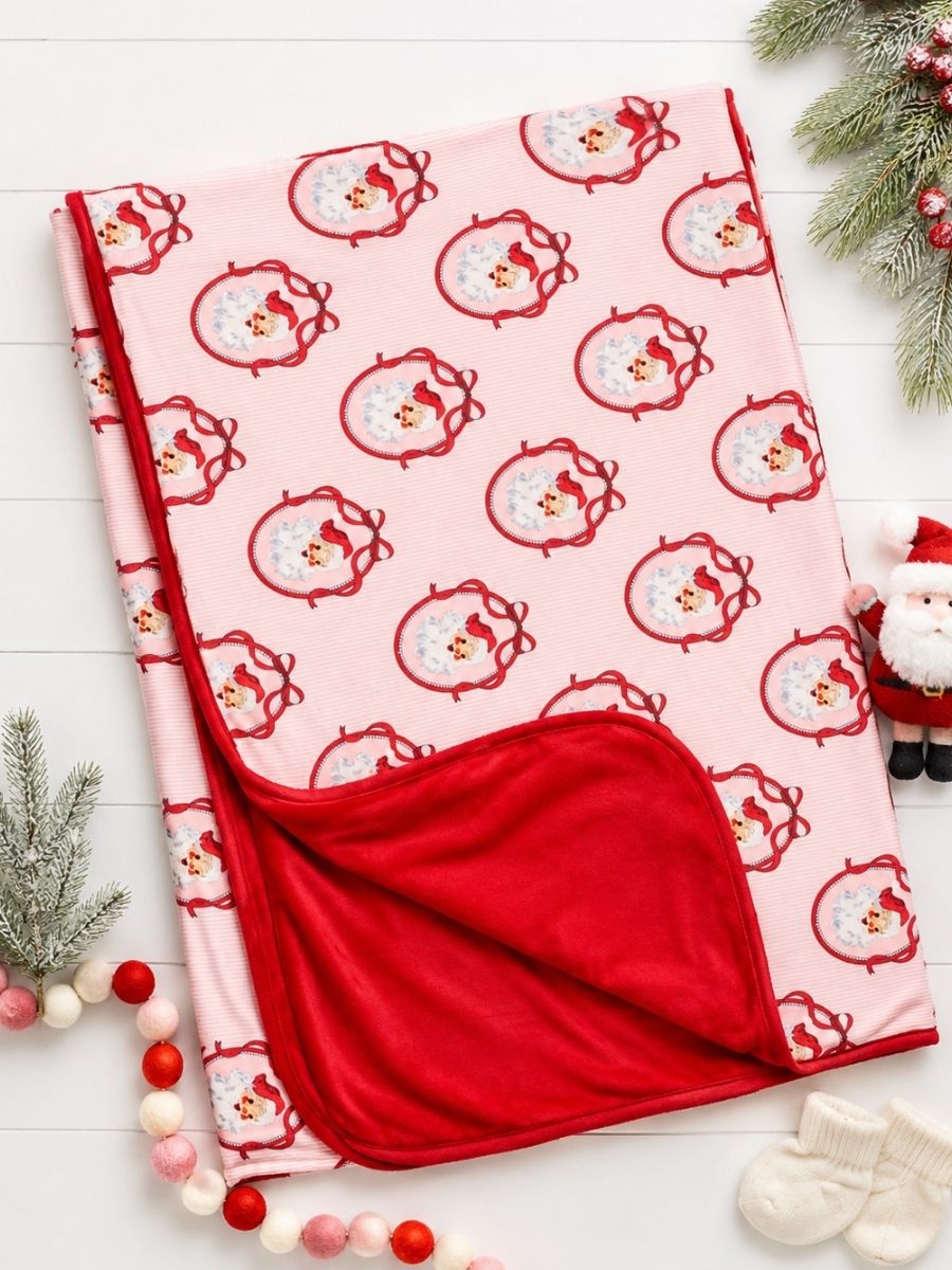 Pink Nutcracker Christmas minky baby blanket in a festive holiday flatlay with vintage Santa print and plush red backing.