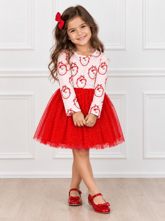 Girls Vintage Santa Christmas tutu dress styled in a festive holiday flatlay with a classic Santa print, glitter red tulle skirt, and coordinating Christmas accessories.
