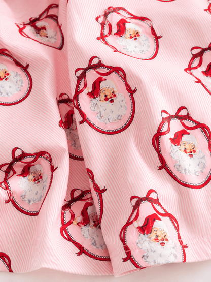Close-up of pink vintage Santa Christmas fabric featuring classic Santa portrait print on soft striped fabric, highlighting the premium holiday design.
