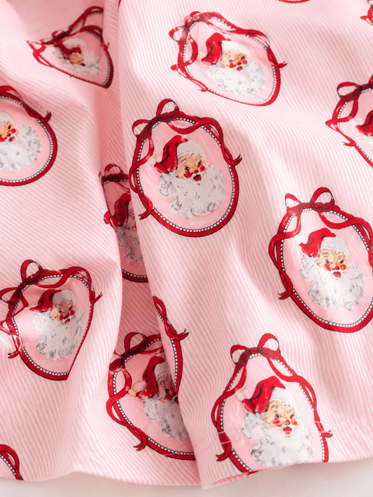 Close-up of pink vintage Santa Christmas fabric featuring classic Santa portrait print on soft striped fabric, highlighting the premium holiday design. - Alternative view