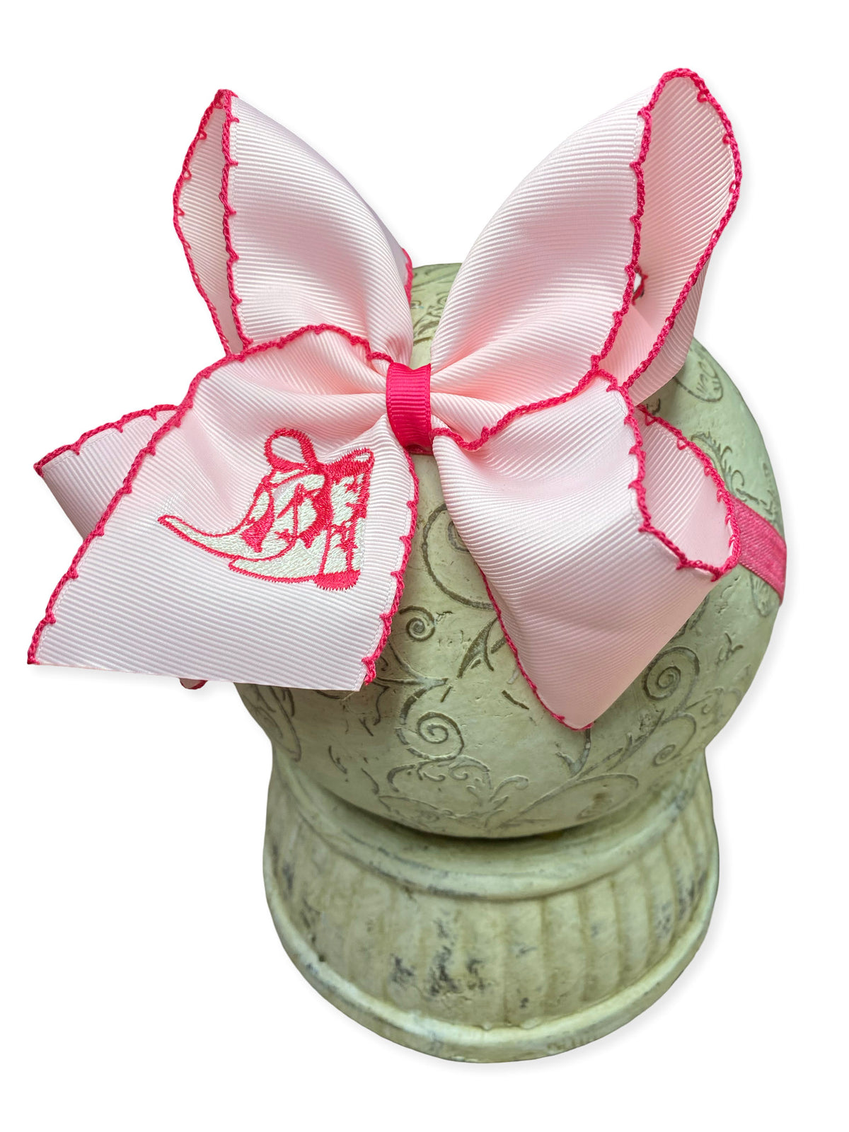 Pink western boot embroidered moonstitch bow headband on a white background