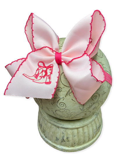 Pink western boot embroidered moonstitch bow headband on a white background
