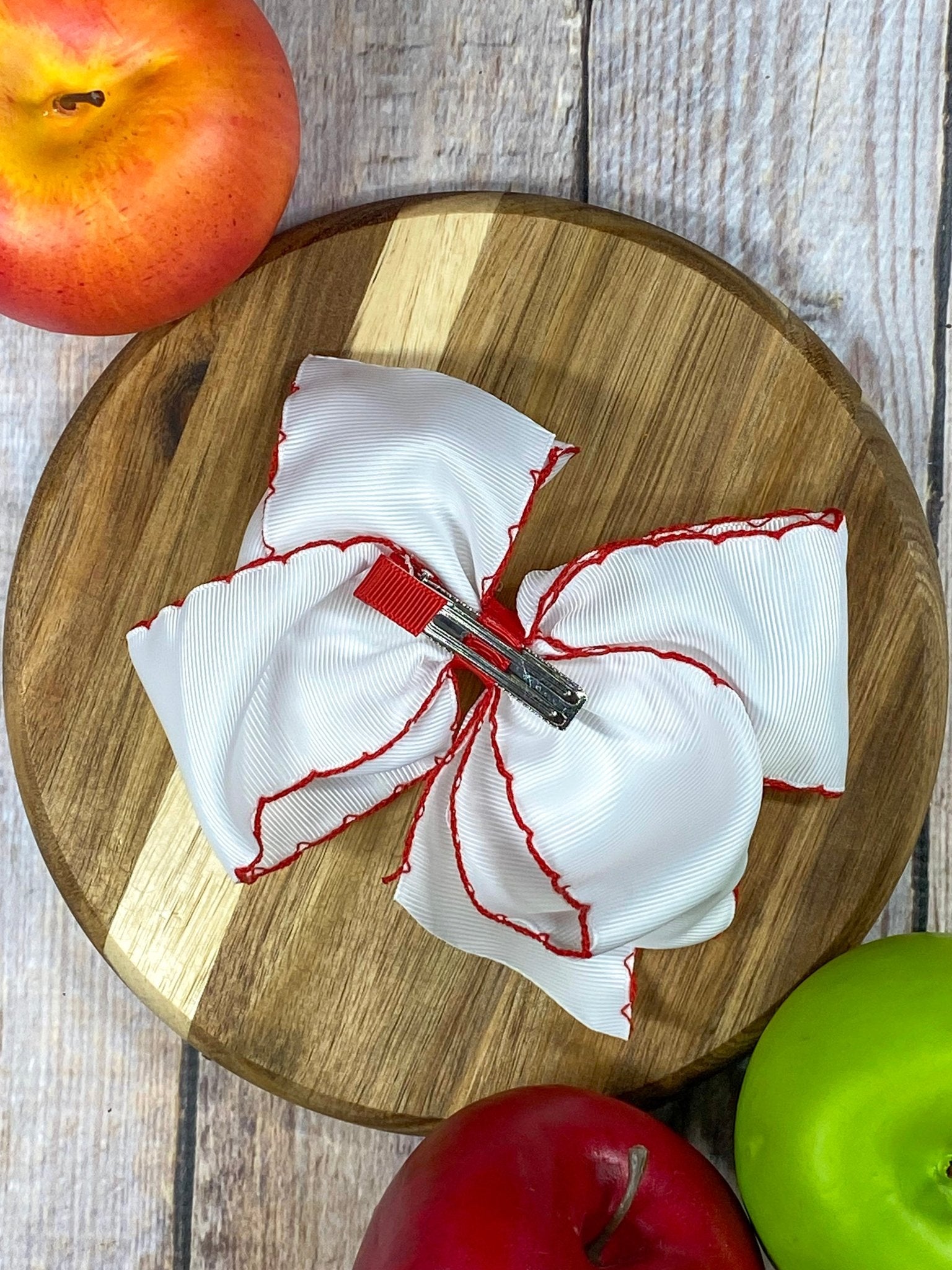 Back of White Apple Embroidered Moonstitch Hair Bow showing alligator clip