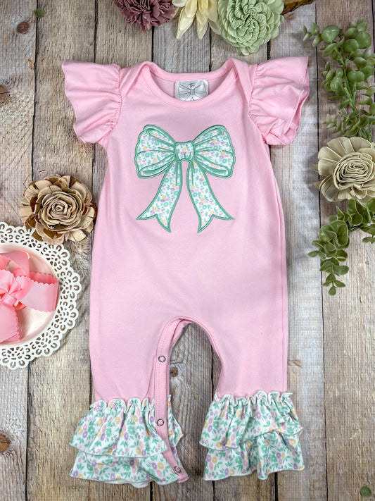 Wildflowers & Bows Infant Onesie on wooden surface