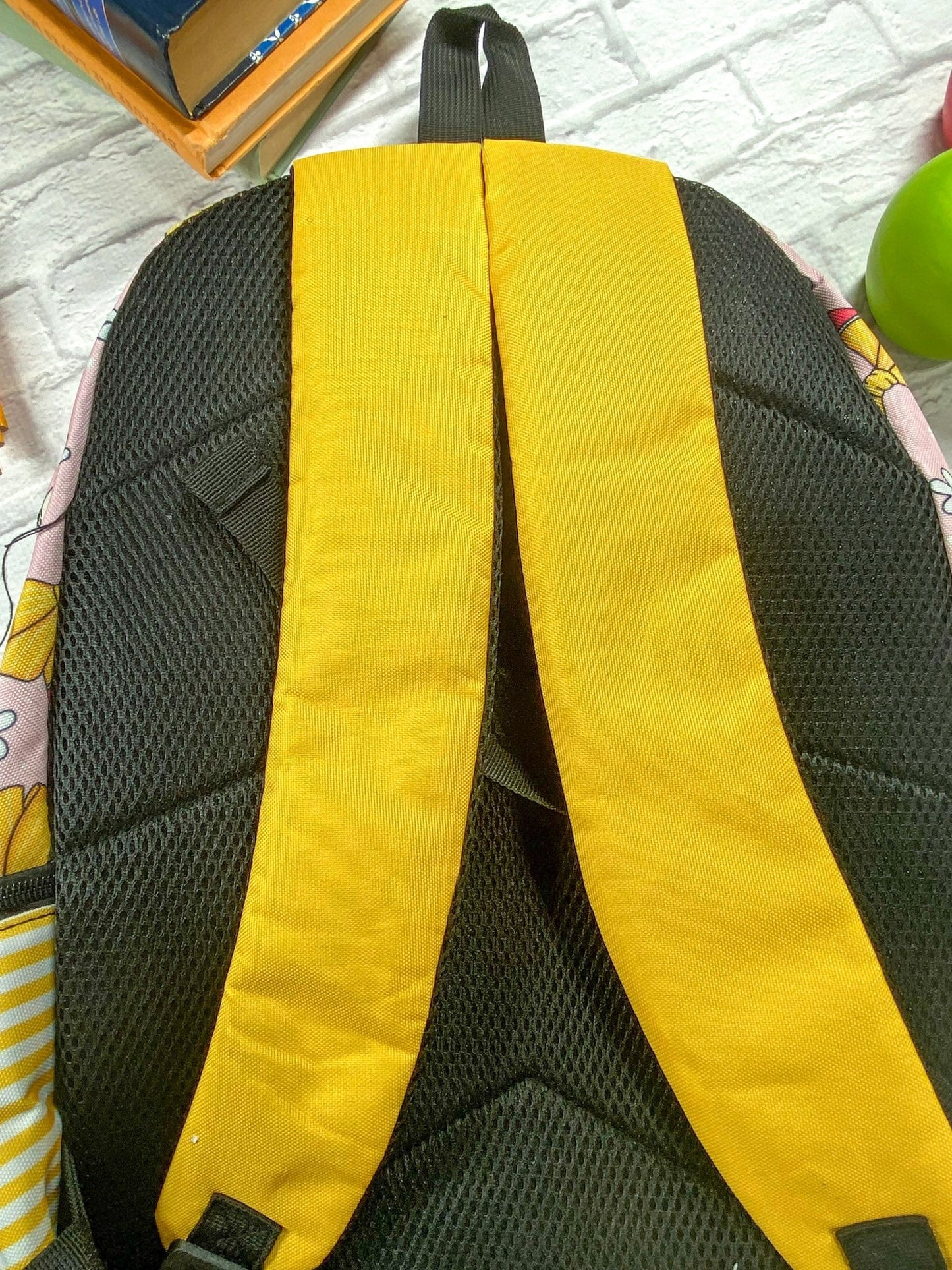 photo of back of the backpack showing the yellow straps